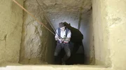 Josh Gates plummets into the darkness of an ancient Egyptian tomb.