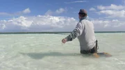Chris Owens fishing the shallows in crystal clear water in the Bahamas.