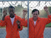 Taylor and Reed behind fence at the County Jail in Florida. Taylor's bold plan is to escape from maximum security prison by means of a smuggled hacksaw and climbing through a ventilation system.