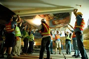 Men installing mural on Great Hall (wow space) ceiling. Men installing mural on Great Hall (wow space) ceiling.