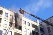 Firefighters extinguish a balcony fire from the turntable ladder in Dresden.