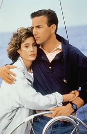 L-R: Susan Atwell (Sean Young) und Tom Farrell (Kevin Costner)
