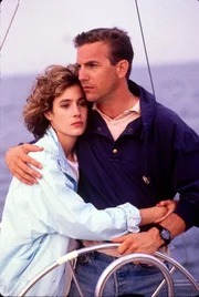 L-R: Susan Atwell (Sean Young) und Tom Farrell (Kevin Costner)