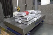 Mehrere Pakete mit mutma&szlig;lichen Bet&auml;ubungsmitteln werden auf eine Waage gelegt, um ihr Gewicht zu bestimmen, nachdem sie von der CBP in San Diego, Kalifornien, aus dem Kofferraum des Fahrzeugs eines Verd&auml;chtigen geholt wurden (National Geographic for Disney).