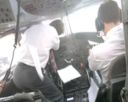 Captain Tim Lancaster is pulled to his feet as the windshield comes off and co-pilot Alastair Atchinson tries to control the plane.