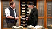 Josh Gates with Fr. Justin of Sinai in the monastery&rsquo;s library in Sinai.
