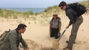 Stefan Burns digs a hole in Mount Baldy as Rob Nelson examines it. They are trying to learn more about the air gaps which are present in the dunes of Mount Baldy. Stefan Burns digs a hole in Mount Baldy as Rob Nelson examines it. They are trying to learn more about the air gaps which are present in the dunes of Mount Baldy.