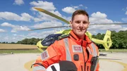 Steve Dawber stood in front of the helicopter with his helmet under his arm (closer image, smiling) Steve Dawber stood in front of the helicopter with his helmet under his arm (closer image, smiling)