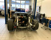 Dino works on the car. Dino works on the car.