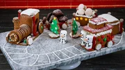 Contestant Lana Witherspoon's dish Gingerbread with Honey and Molasses, Hazelnut French Macaron with Chocolate Hazelnut Buttercream, and Chocolate Hazelnut Cookie during the second round, The Display Challenge, "Christmas Cookie Train", as seen on Christmas Cookie Challenge, Season 2.