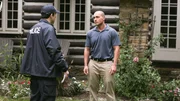 A man talking to the police in front of a house.