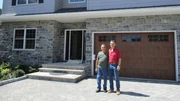 The new lottery winners pose in front of their new dream home, as seen on My Lottery Dream Home.