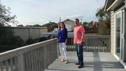 Contributors Rebecca Heitz (L) and Bob Heitz (R) check out the views of the large yard from the back porch of Sea Walk as seen on HGTV's Beachfront Bargain Hunt.