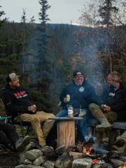 Ness crew all gathered around fire pit for gold weigh