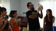 Antonio Ballatore holds up Giuseppe the chinchilla while the Diazes Lizzy, Lisa, and Jacquelyn laugh.