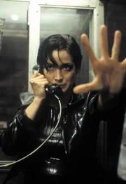 Trinity (Carrie-Anne Moss) nimmt den Ausgang aus der Matrix: Eine &ouml;ffentliche Telefonzelle.