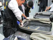 LIMA - Suitcase being destroyed.