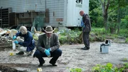 Det. squats down examining evidence. Det. squats down examining evidence.