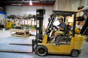 Jose driving forklift in warehouse.