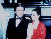 Für ein Modemagazin lassen sich Jonathan (Robert Wagner, l.) und Jennifer (Stefanie Powers, r.) in ihrem Zuhause in den Kreationen des Modeschöpfers Vollbracht ablichten.