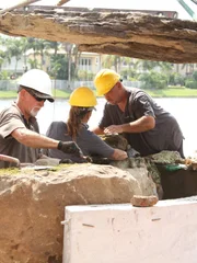 L-R: John "Old Man" Messner, Jane "Woman" Werley, and Chris "Crash" Warren install rocks.