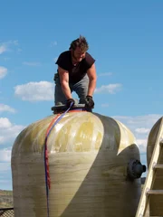 Gabe sourcing water tanks at junkyard.