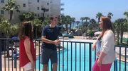Contributors Ashley Hughes (L) and Brandon Hughes (C) chat with real estate agent Callan Edick (R) by the beautiful pool area at Destin West as seen on HGTV's Beachfront Bargain Hunt.