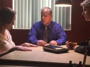 Sharon being investigated by the detectives.