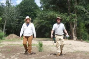 L-R: Misty Raney and Nicholas Babbit walking in a dirt field.