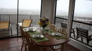 The dining room in Salty Bungalow is large with incredible views of Matagorda, Texas as seen on HGTV's Beachfront Bargain Hunt.