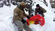 Grady Powell and Bo McGlone sorting through the parachute in Wyoming.