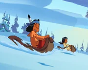 Yakari und Regenbogen fahren Schlitten.