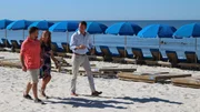Contributors Gene Meyer (L) and Denia Meyer (C) are all smiles as they chat with real estate agent Cain McNeil (R) after touring Emerald Beach Resort as seen on HGTV's Beachfront Bargain Hunt.