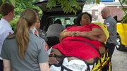 Marla on a stretcher with paramedics outside. Marla on a stretcher with paramedics outside.