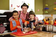 Heute wird gejodelt und geschunkelt, denn im Koch-Kids-Club gibt es Hausmannskost! Estelle, Elias und Profikoch Alex tischen einen deftigen Schweinebraten mit Kartoffelknödeln auf.