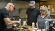 Chef Robert Irvine shows Leah Fogle & Chris Fogle, Leah's Korner Kafe, how to make the entr&eacute;es from the new menu at Leah's Korner Kafe in Coleman, MI, as seen on Restaurant: Impossible Season 20.