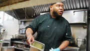 Jared, chef of Ship Inn, shows his cooking skills to Chef Robert Irvine in the kitchen of the restaurant.
