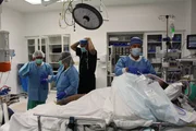 Doctors preparing Liz for lymphedema removal surgery. Doctors preparing Liz for lymphedema removal surgery.