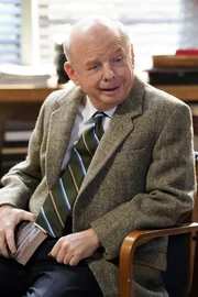 Dr. John Sturgis (Wallace Shawn)