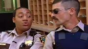 L-R: Deputy S. Jones (Cedric Yarbrough), Deputy Travis Junior (Robert Ben Garant)
