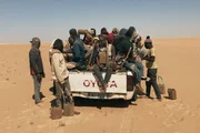 Migranten auf einem Pickup in der Sahara Migranten auf einem Pickup in der Sahara