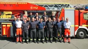 Firefighters in front of the turntable ladder in Bielefeld.