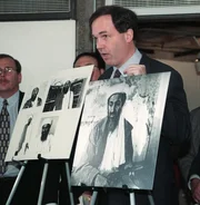 NEW YORK, UNITED STATES:  Assistant US Attorney Patrick Fitzgerald (R) shows photos of alleged terrorist Osama Bin Laden at a news conference in New York, NY 04 November.  Osama Bin Laden was indicted 04 November in Manhattan federal court for the 07 August bombings of the US embassies in Nairobi, Kenya, and Dar es Salaam, Tanzania, and for conspiring to assassinate US citizens outside the United States.   AFP PHOTO/Henny Ray ABRAMS (Photo credit should read HENNY RAY ABRAMS/AFP via Getty Images)