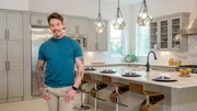Host David Bromstad poses for a photo in this modern kitchen in Orlando, Florida, as seen on Lottery Dream Home. (portrait)