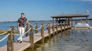 Host David Bromstad enjoys a moment on the private dock in Orlando, Florida; as seen on Lottery Dream Home. (Portrait).