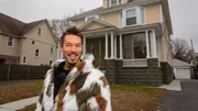 As seen on My Lottery Dream Home, host David Bromstad stands in front of the Newton Hills home in Worcester, Massachusetts. Portrait, Exterior