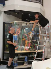 Wayde and Brett put sand in the tank.