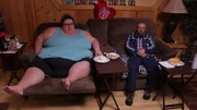 Bri and husband eating on recliners.