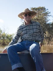 Ray Matherne sailing his motorboat along the river. Ray Matherne sailing his motorboat along the river.