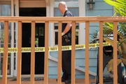 Police officer looking into the crime scene.